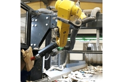 Image Automated robot operating machinery in a factory.